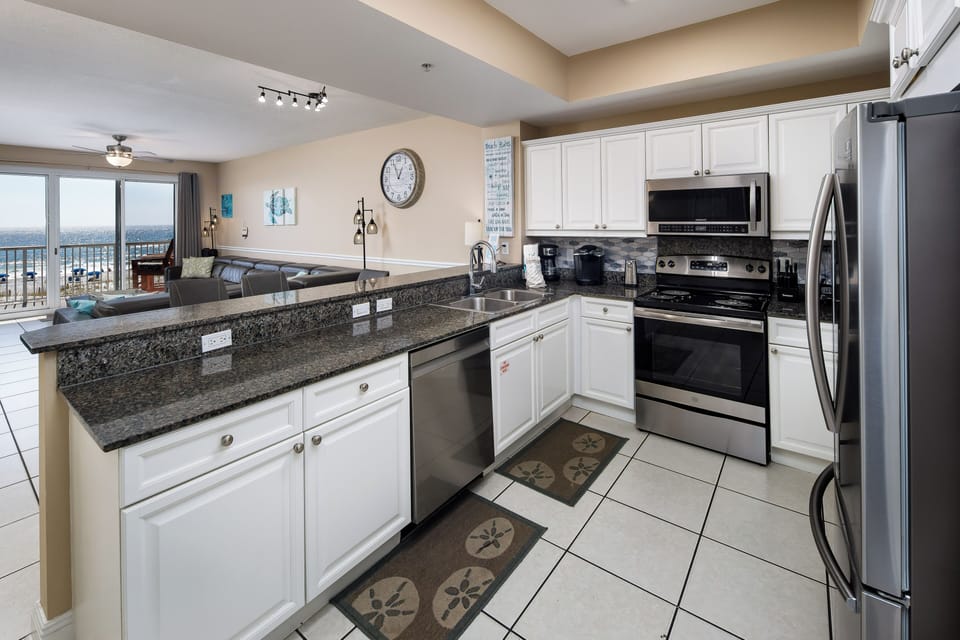 Kitchen - The deep rich tone of the granite accentuates the appliances and white cabinetry