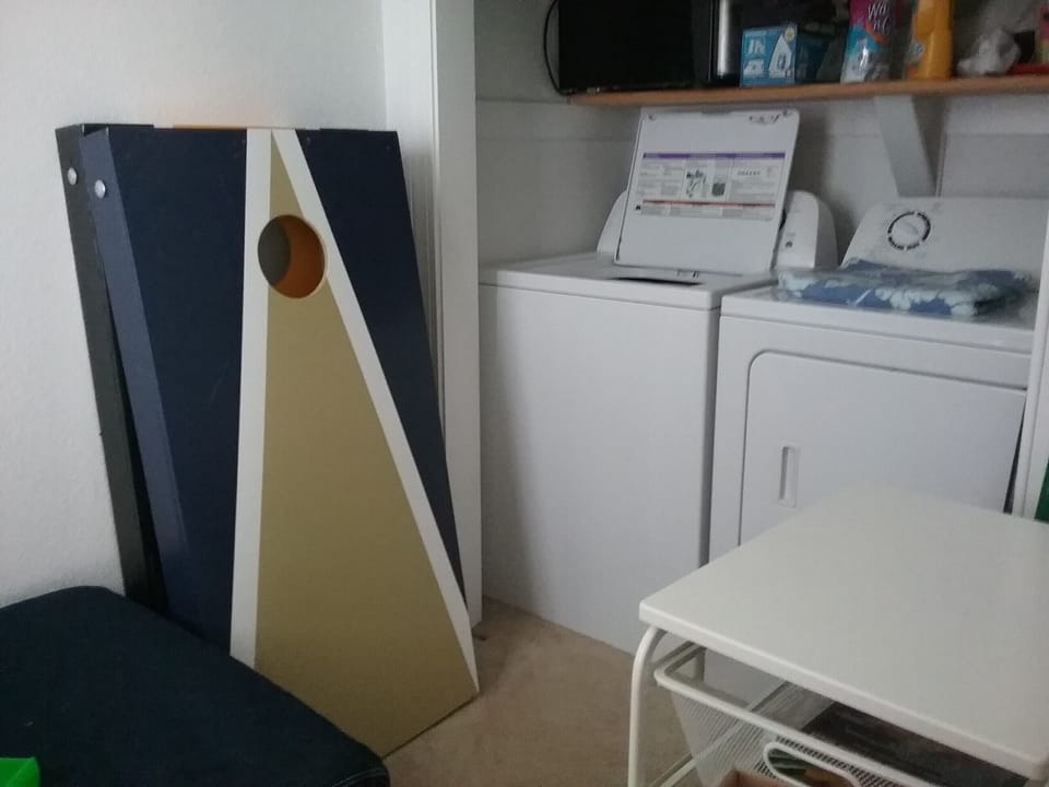 Laundry and corn hole game. - Corn hole game