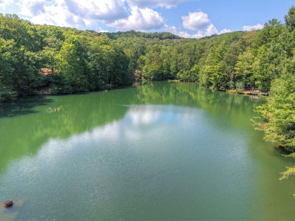 The still waters of Cherry Lake stretch out in front of a Blue Ridge cabin rental, ideal for fishing at sunrise or soaking up the peaceful North Georgia setting