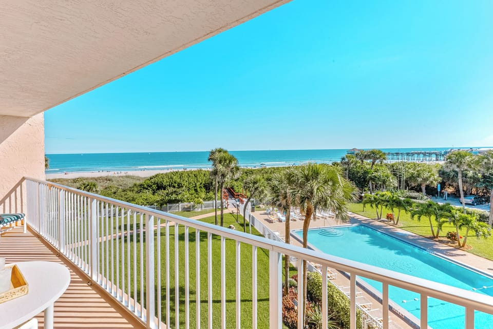 Relax on the balcony with direct ocean views overlooking cocoa beach pier