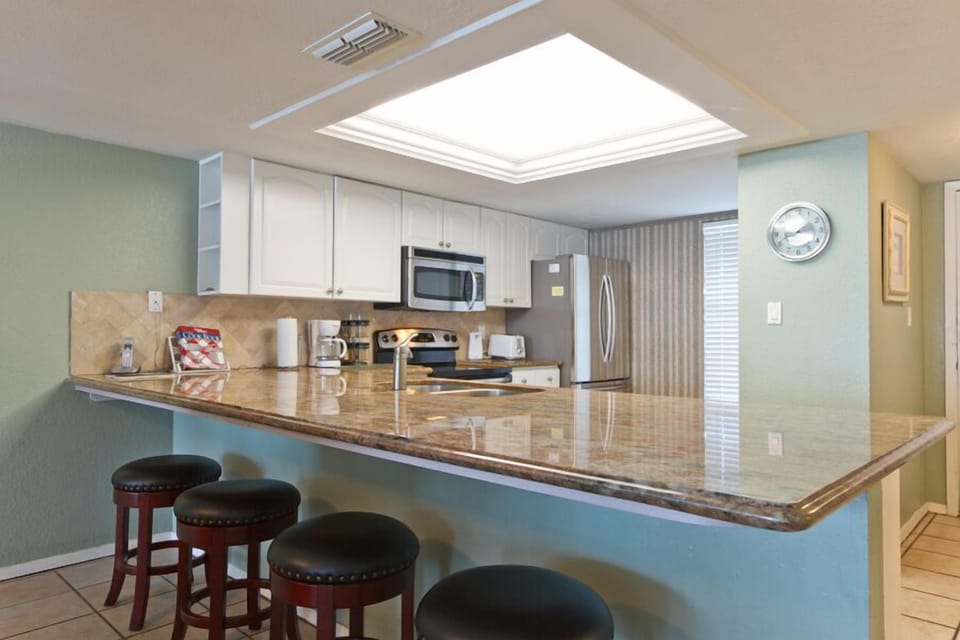 Our kitchen has an attached breakfast bar with seating for 4.