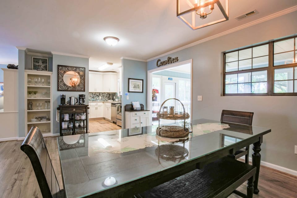 The dining table is located just off of the kitchen.