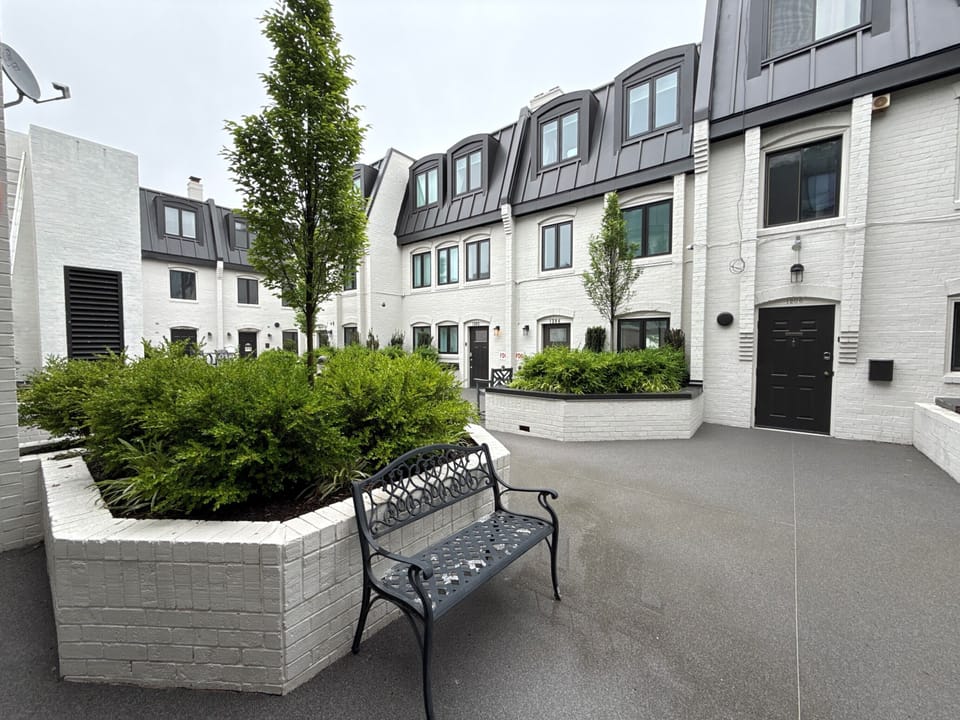 View from condo entrance to communal patio with seating