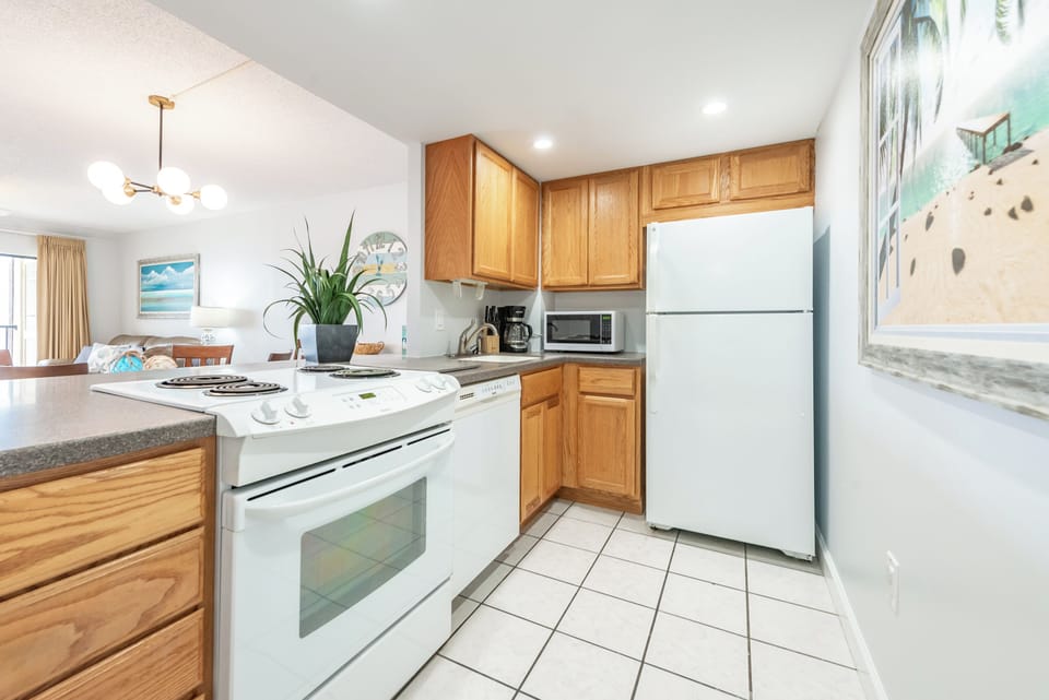 Fully equipped kitchen with classic wooden cabinetry and bright lighting