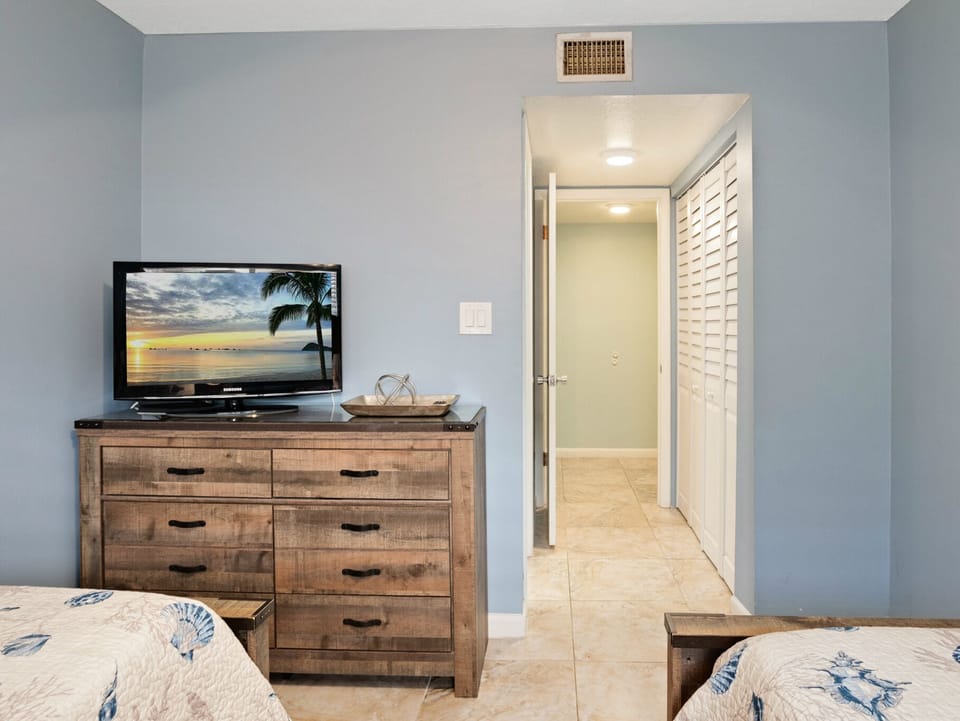 Guest bedroom with TV and dresser