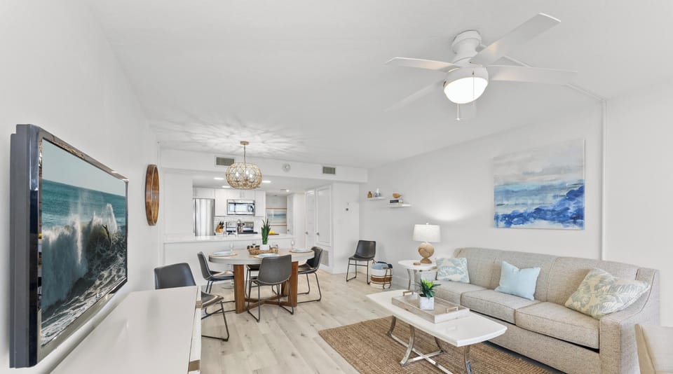 Spacious open-concept living area with stylish decor, soft lighting, and a relaxed coastal vibe.