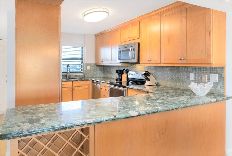 Stylish kitchen with granite countertops and warm wood cabinets.