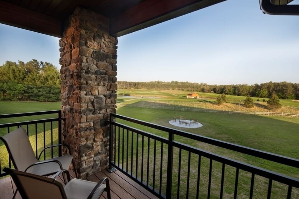 Balcony Includes Two Chairs with an Attached Table in Between. View of the Shared Fire Pit and Golf Course