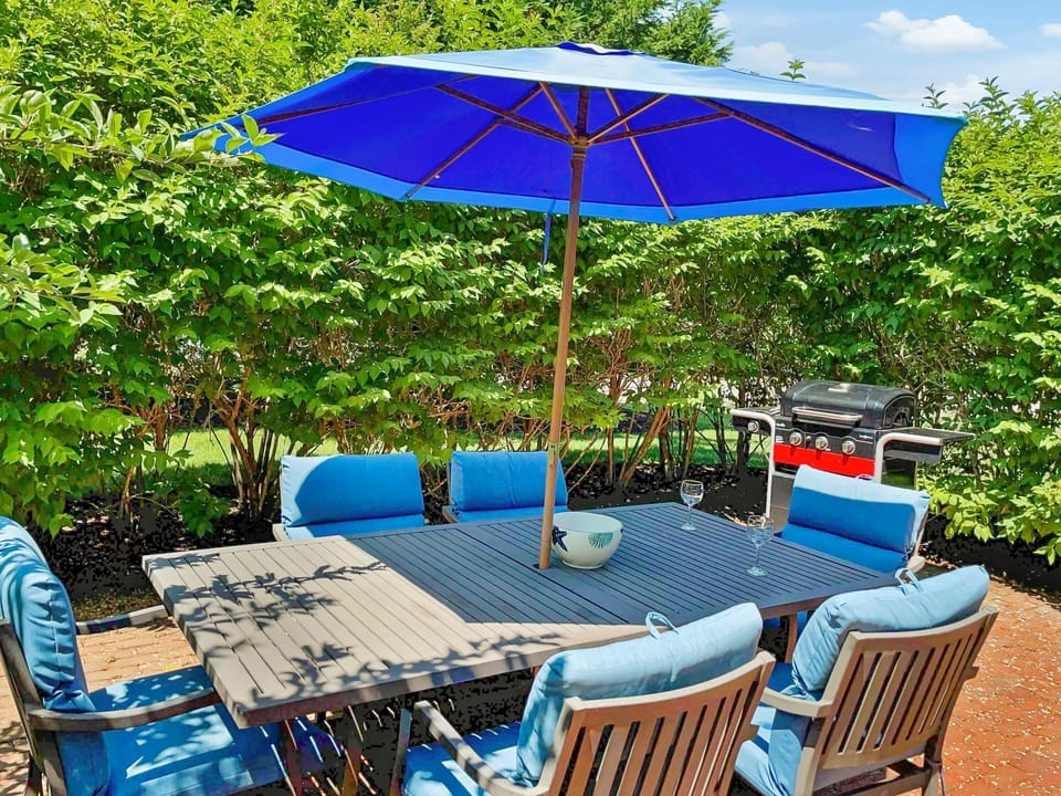 Patio with grill and outdoor dining set with umbrella