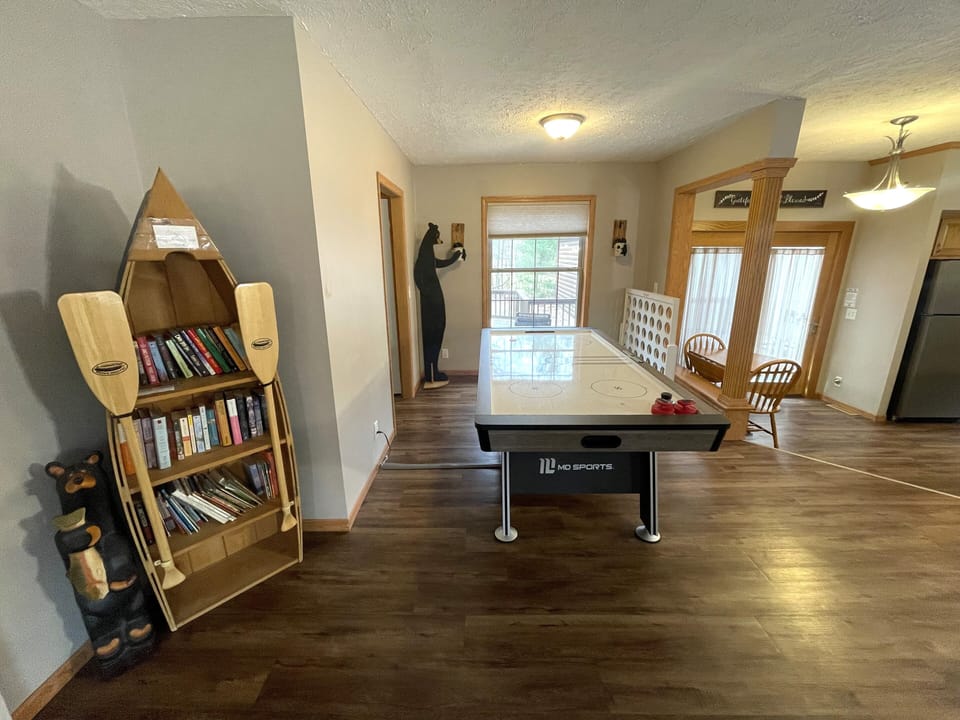 First Living Room with Cozy Seating, Queen Sofa Sleeper, Air Hockey Table & Giant Connect 4