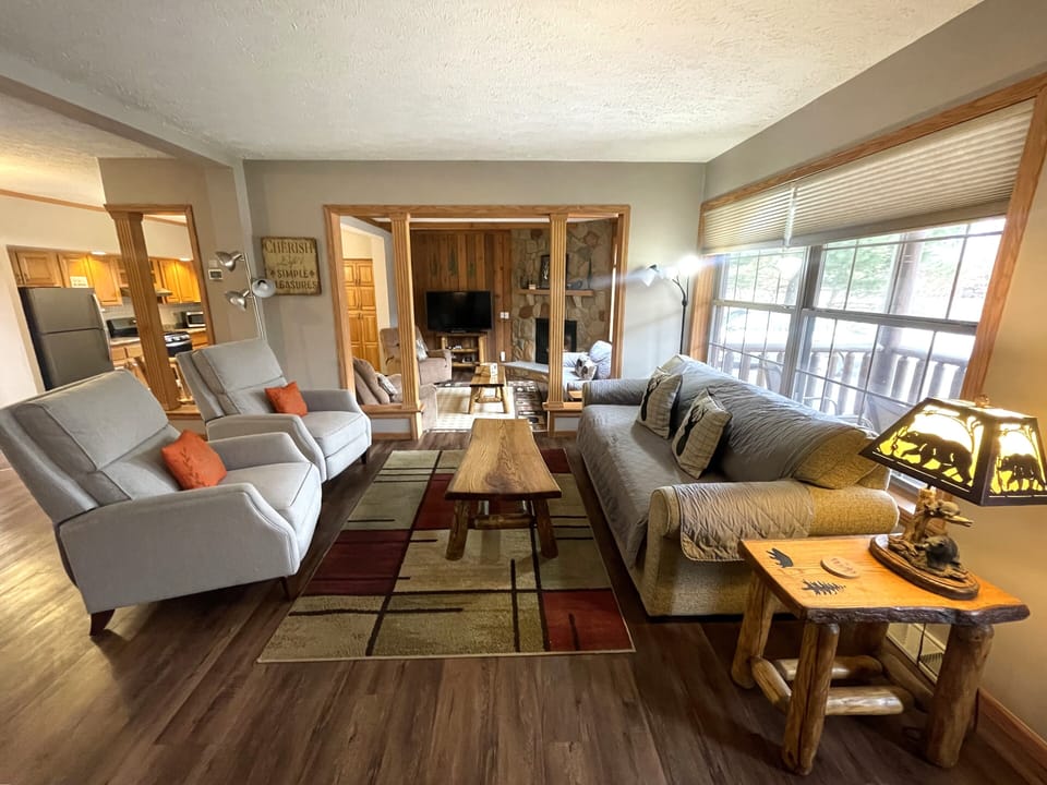 First Living Room with Cozy Seating, Queen Sofa Sleeper, Air Hockey Table & Giant Connect 4