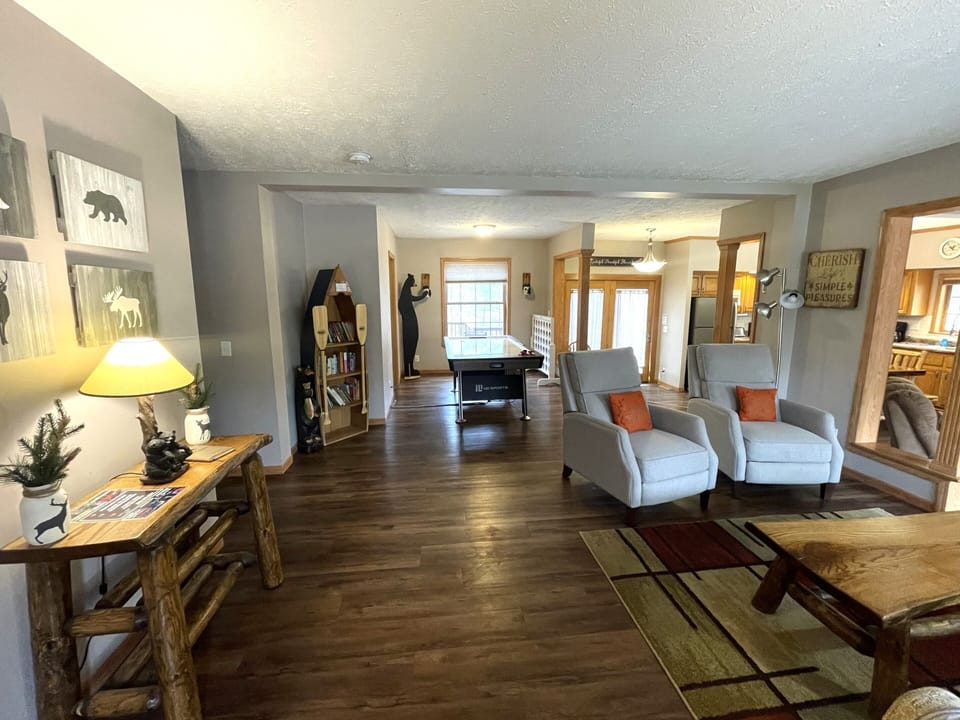 First Living Room with Cozy Seating, Queen Sofa Sleeper, Air Hockey Table & Giant Connect 4