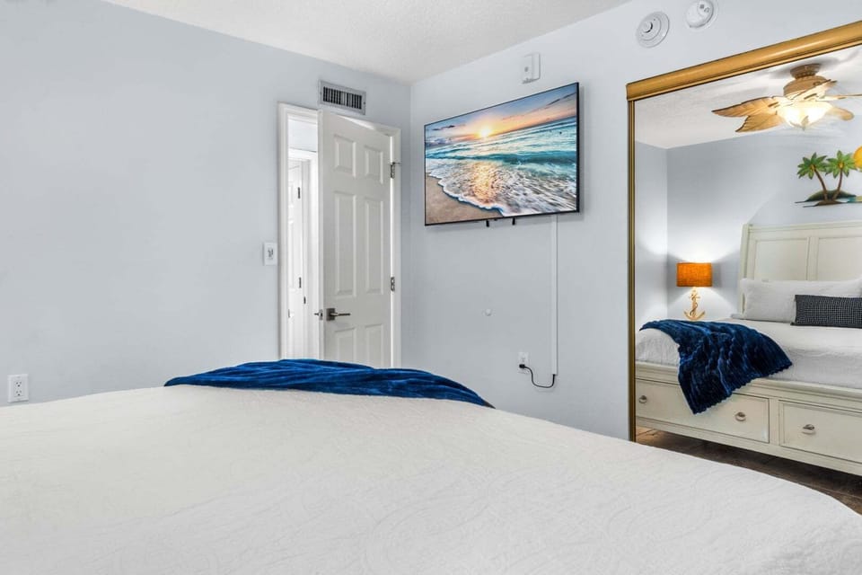 The guest bedroom features a smart TV