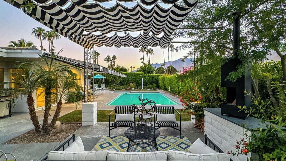Pergola With Lounge Seating Overlooking Large Pool and Spa