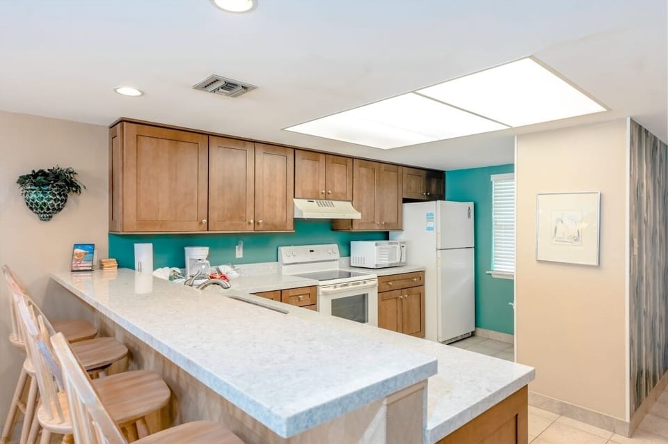 Our kitchen has a breakfast bar perfect for entertaining your guests while you whip up snacks.