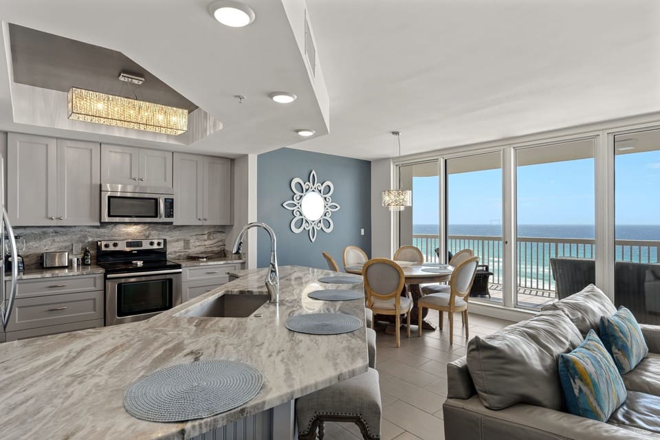 Your oceanfront escape features a stunning open-concept space where you are able to cook meals while soaking in breathtaking beach views.