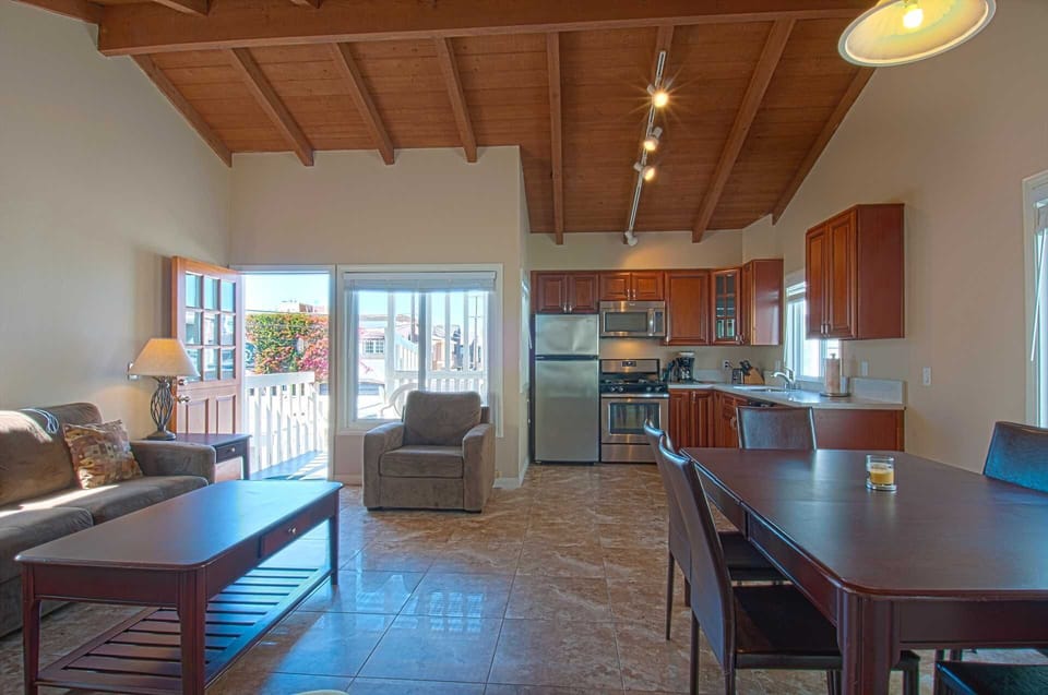 Inside photo showing family, kitchen & dining area