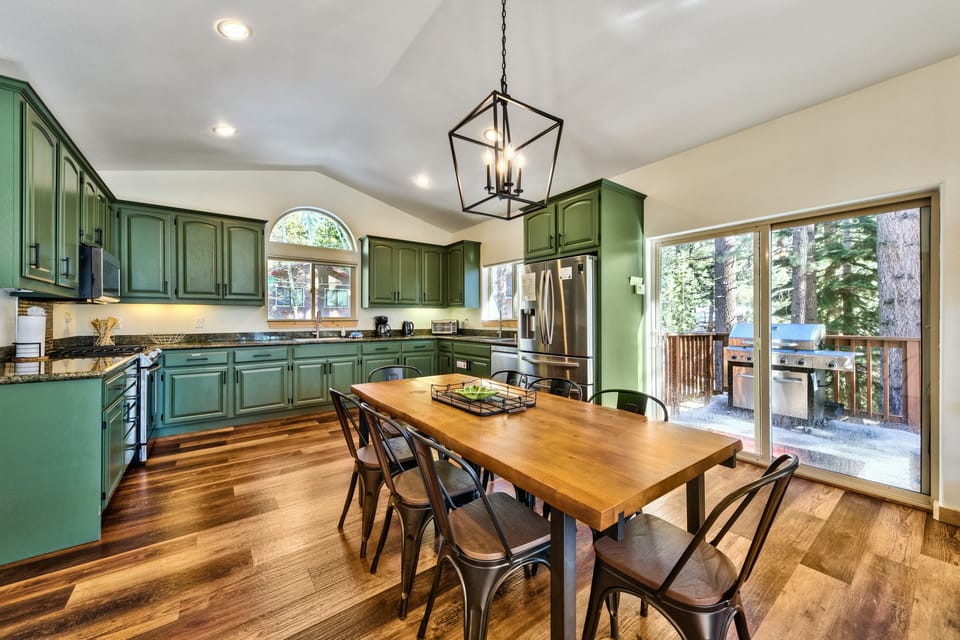Cook memorable meals in this stylish kitchen with sage cabinets, granite counters, and dining space that opens to your private deck.