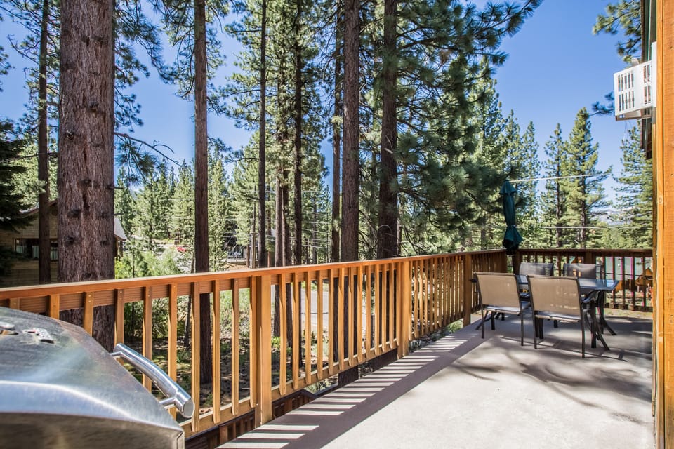 Step onto your private deck surrounded by towering pines, where morning coffee and peaceful forest views create the perfect mountain escape.