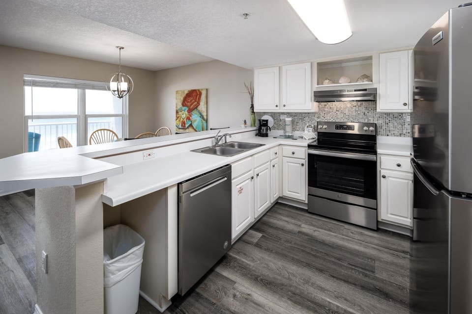 Kitchen - Full service kitchen with white cabinetry and stainless steel appliances