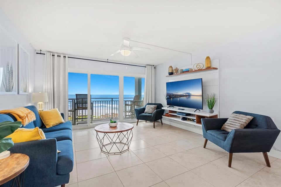 Relax in this bright & airy living room with ocean front views