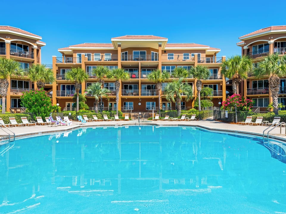 This vacation property features spacious balconies, tropical landscaping and a resort style pool  .