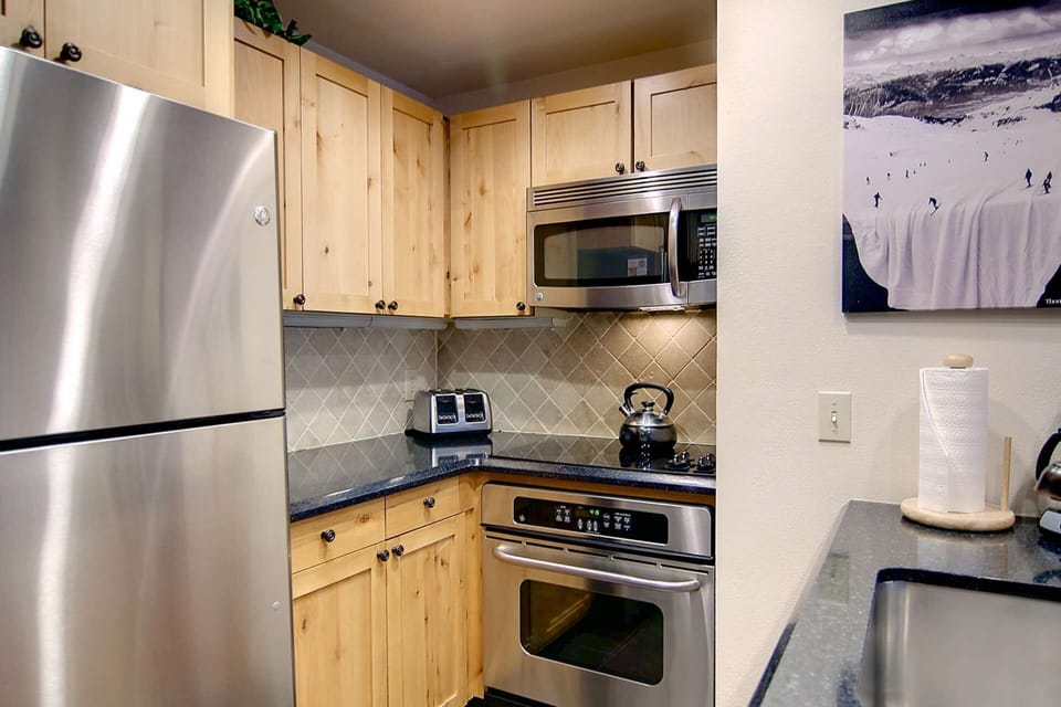 Updated kitchen with stainless steel appliances and granite counters.