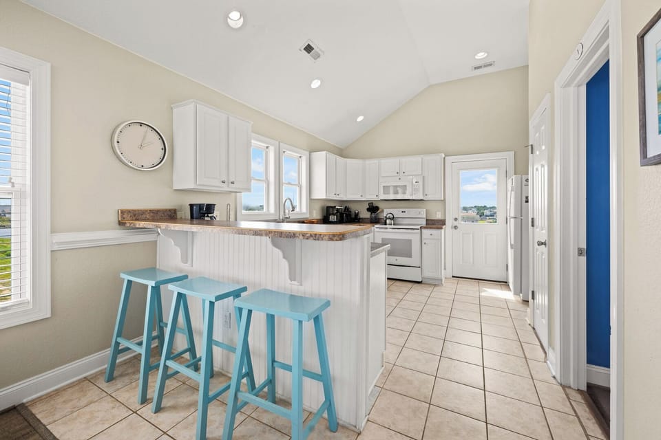 Kitchen with Bar Stool Seating on Third Level