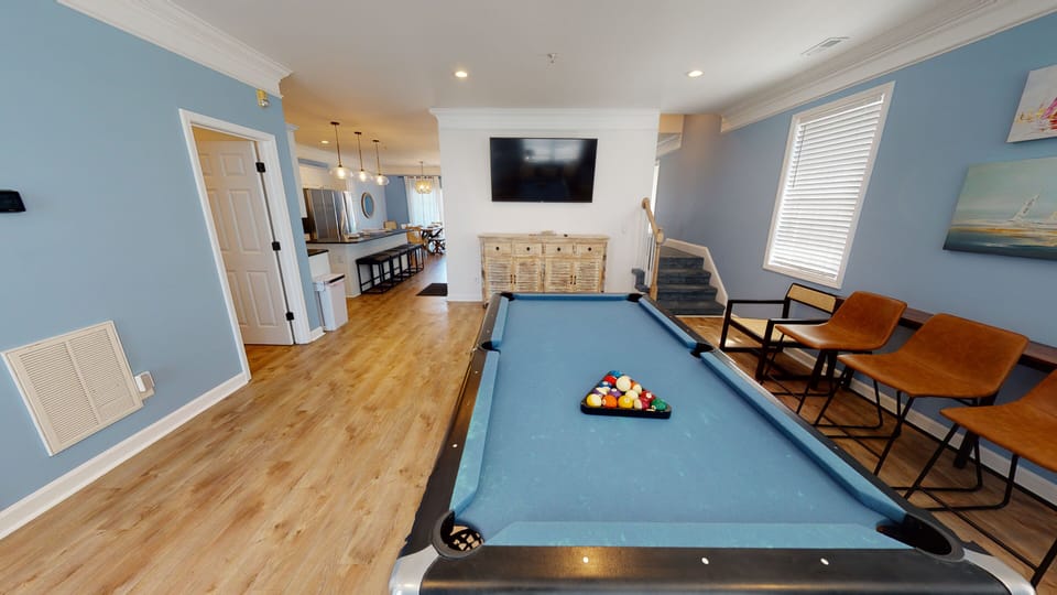Enjoy friendly competition with a pool table and wall-mounted TV.