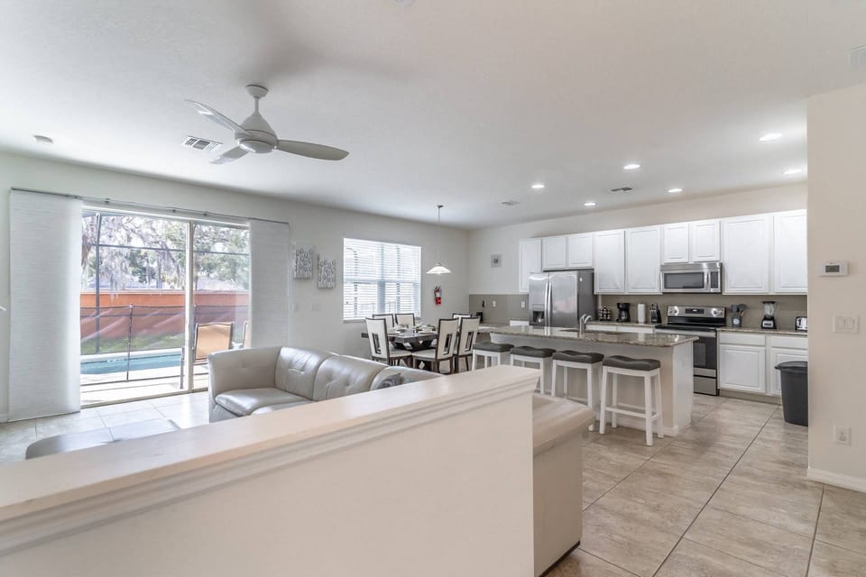 Modern, bright and inviting open concept living, dining and kitchen with access to the private pool!