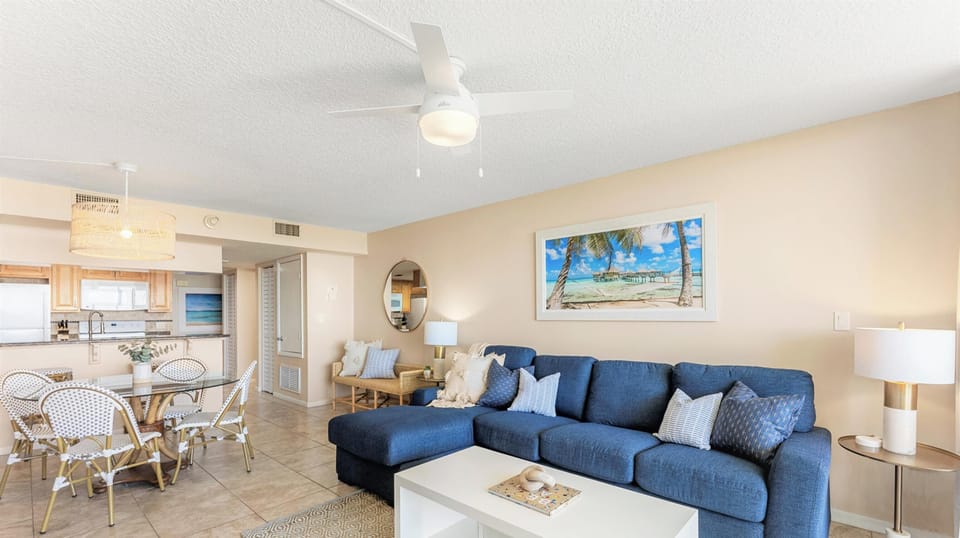 Cozy and stylish living room with a comfortable sofa, beachy decor, and a warm atmosphere.