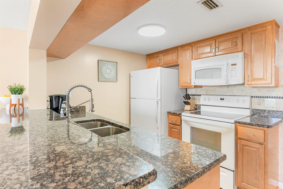 Cook in this fully equipped kitchen with granite counters while overlooking the ocean.