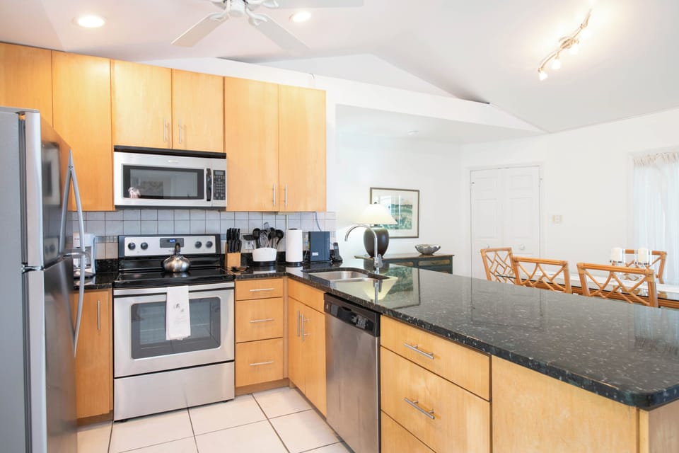 A modern kitchen overlooks the dining area and comes equipped with modern appliances.