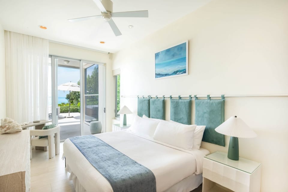 The guest room has a king bed, bathroom, and patio access