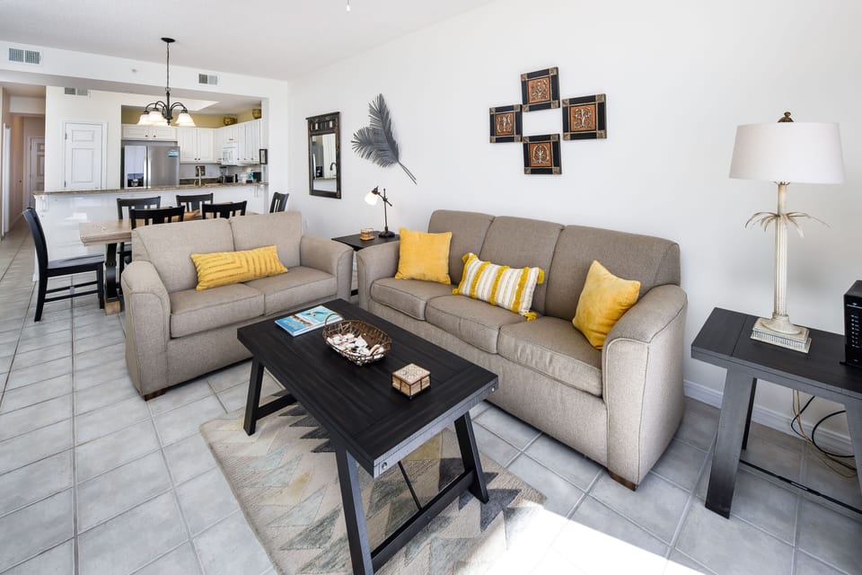 Living Room - Relax in the spacious beach front living room offering plenty of seating for everyone. The sofa is a queen sleeper!