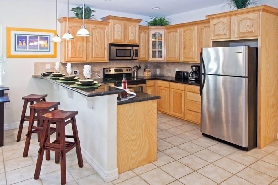 Our breakfast-bar overlooking the kitchen makes entertaining a breeze while you whip up tasty treats.