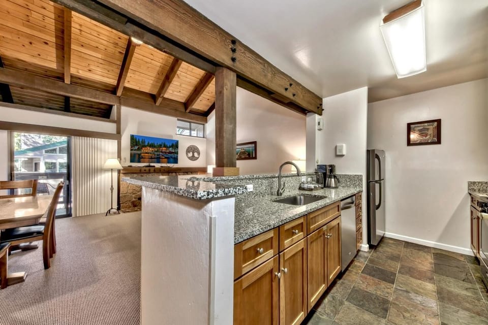 Cook memorable meals in your spacious kitchen with granite counters, wooden beams overhead, and rustic charm throughout.