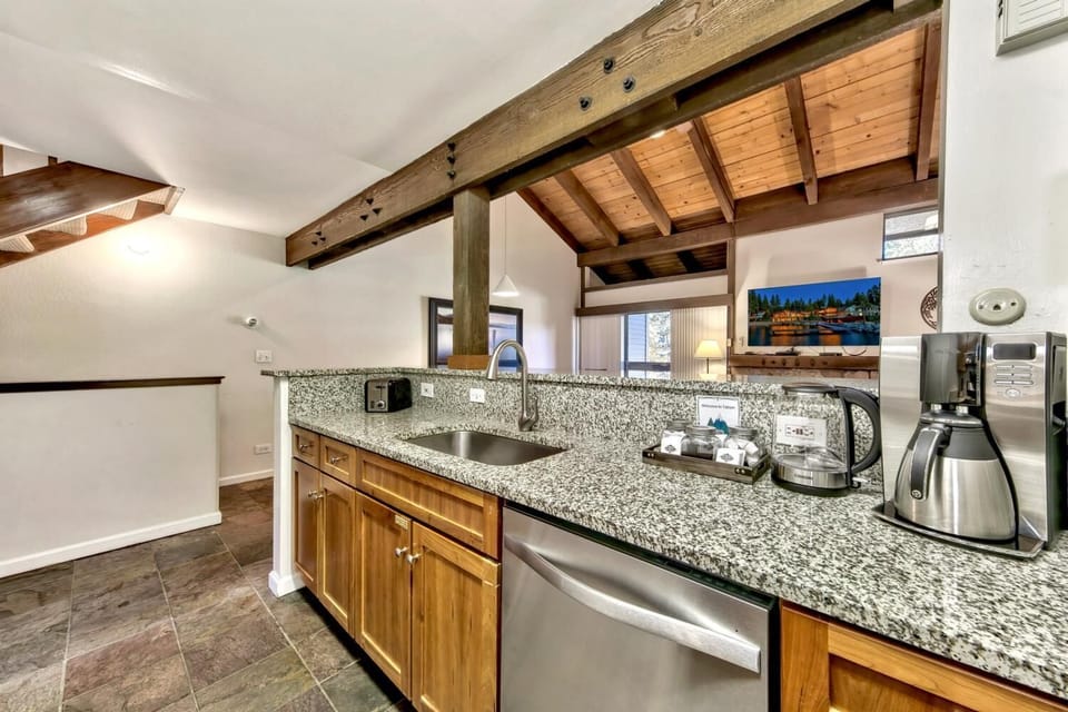 Your fully-equipped kitchen features granite countertops, stainless steel appliances, and rustic exposed beams for memorable meal prep.