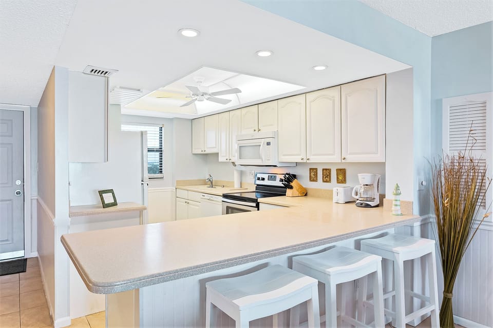Spacious kitchen with modern appliances and a cozy breakfast bar