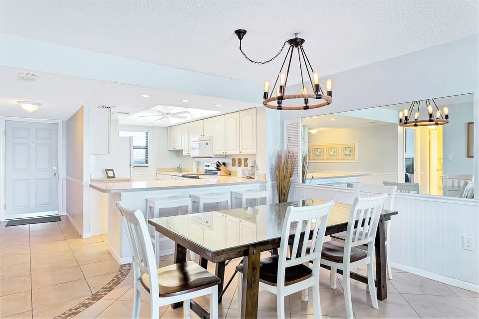 Inviting dining area seats four and breakfast bar seats three, perfect for shared meals.