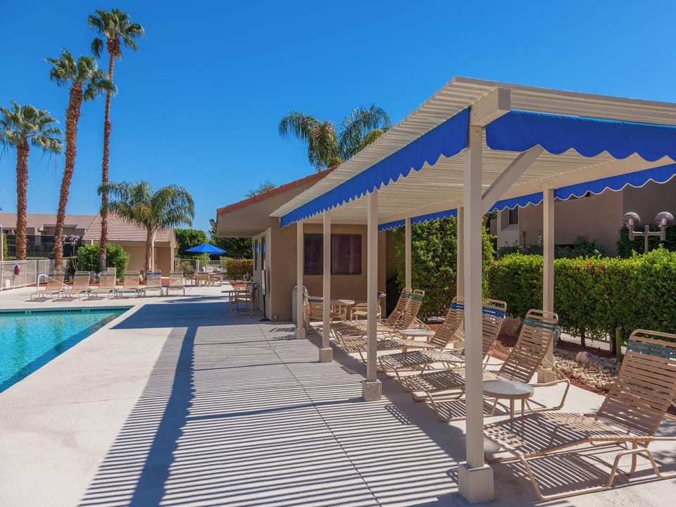 Covered poolside lounge chairs