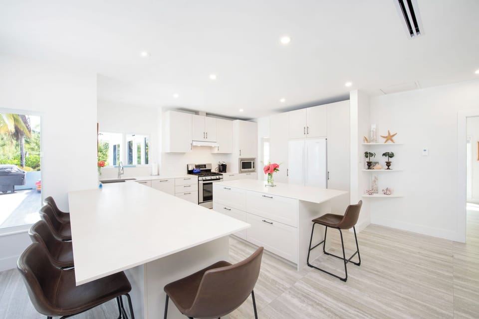 Renovated kitchen with peninsula seating and kitchen island.  
