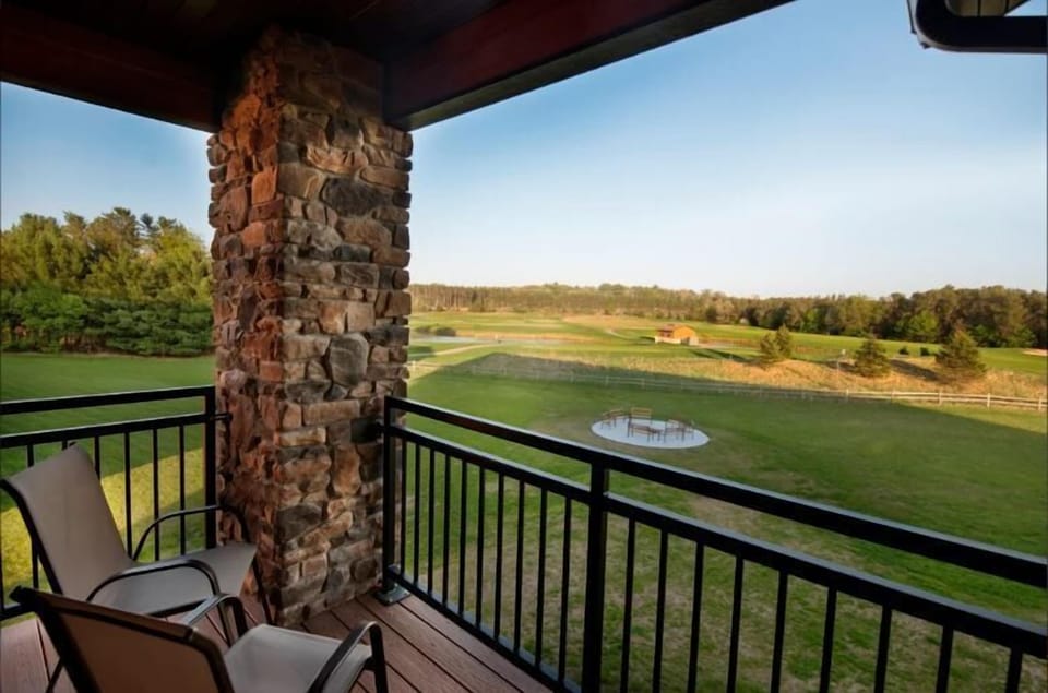 Patio Includes Two Chairs with an Attached Table in Between. View of the Shared Fire Pit and Golf Course