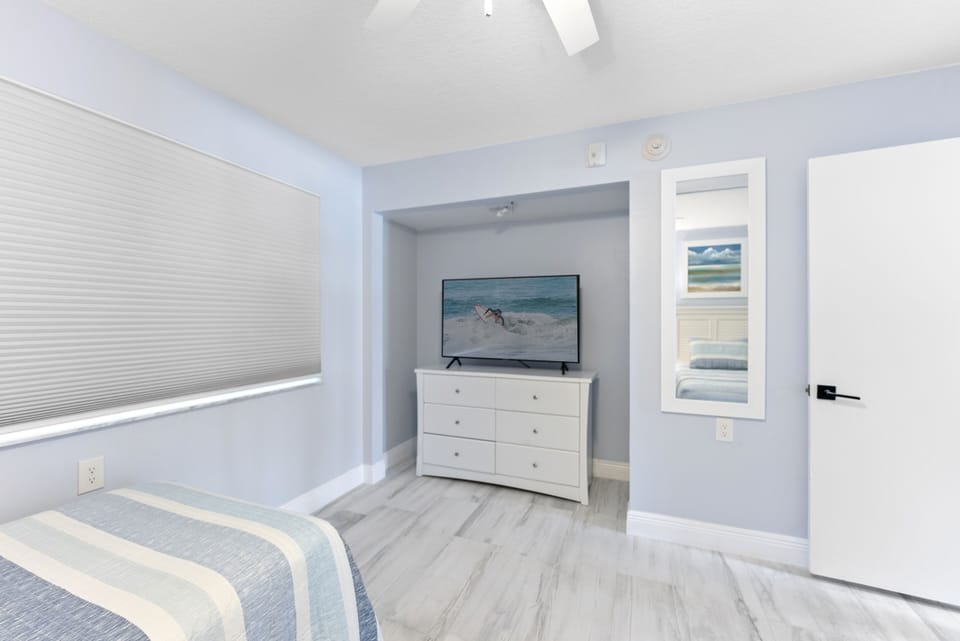 A peaceful and private bedroom featuring a TV