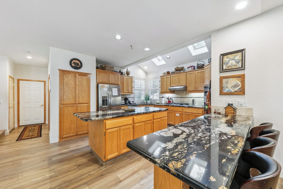 Your spacious gourmet kitchen features stunning granite countertops, premium appliances, and a breakfast bar where you'll love gathering for morning coffee.