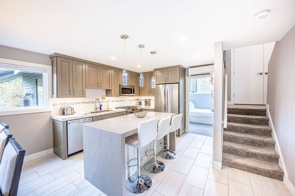 The Fully Stocked, Gourmet Kitchen Features High End Bosch Appliances, Breakfast Bar w Waterfall Edge, Under Cabinet Lighting, Keurig Coffee Maker, Ga