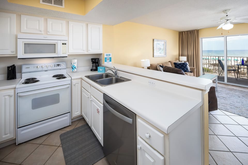 Kitchen - The kitchen has full-size appliances and is stocked with dishes and cooking supplies for all your vacation meal needs.