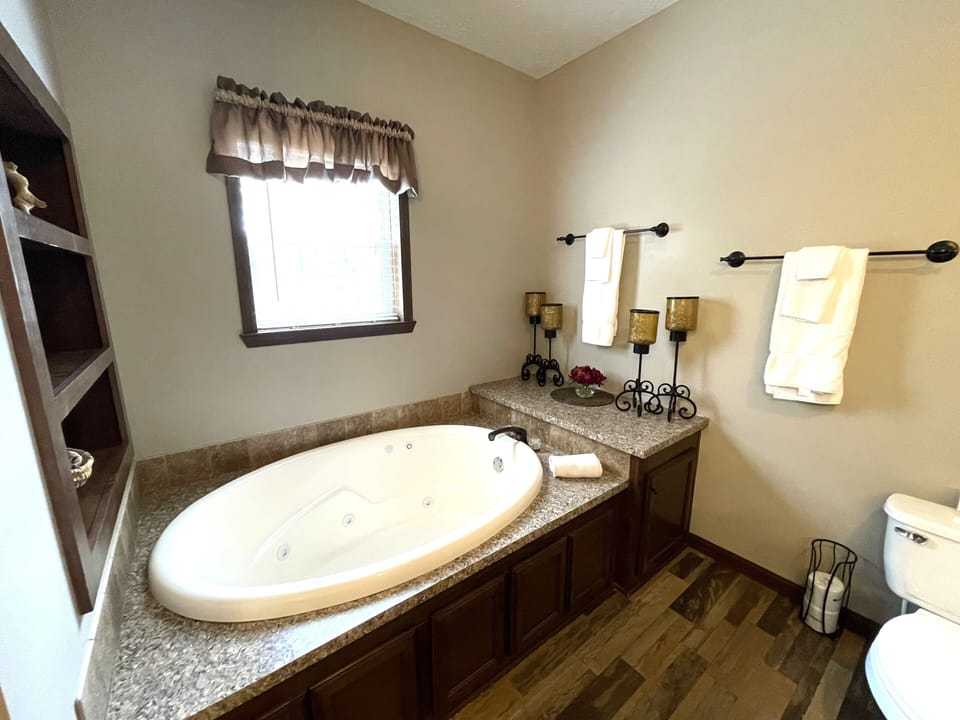Primary Bathroom 1 with Walk-In Shower & Whirlpool Tub on Main Level