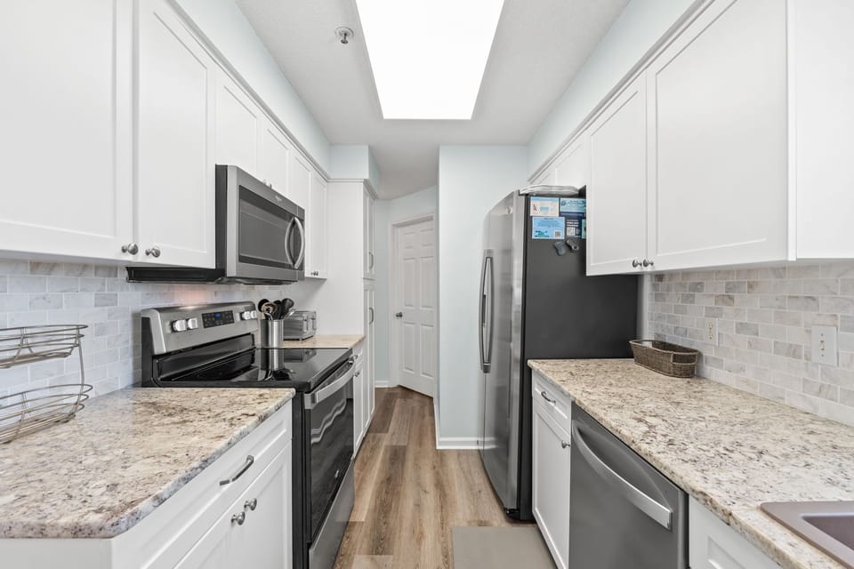 Kitchen - Features stainless steel appliances with lots of cabinet & counter space.
