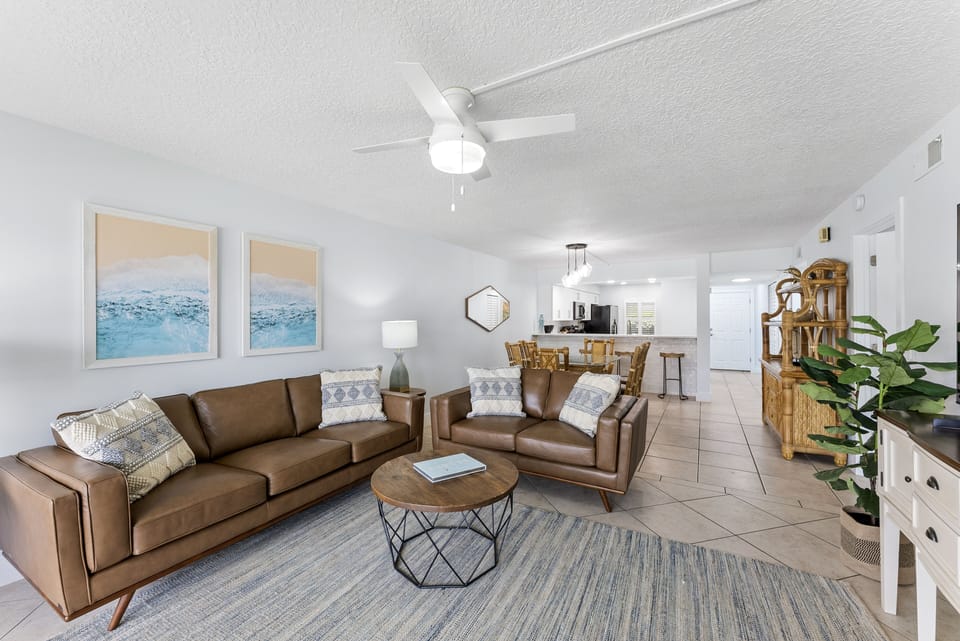 Stretch out on cozy leather sofas in this roomy living space with a large screen TV and coastal art touches